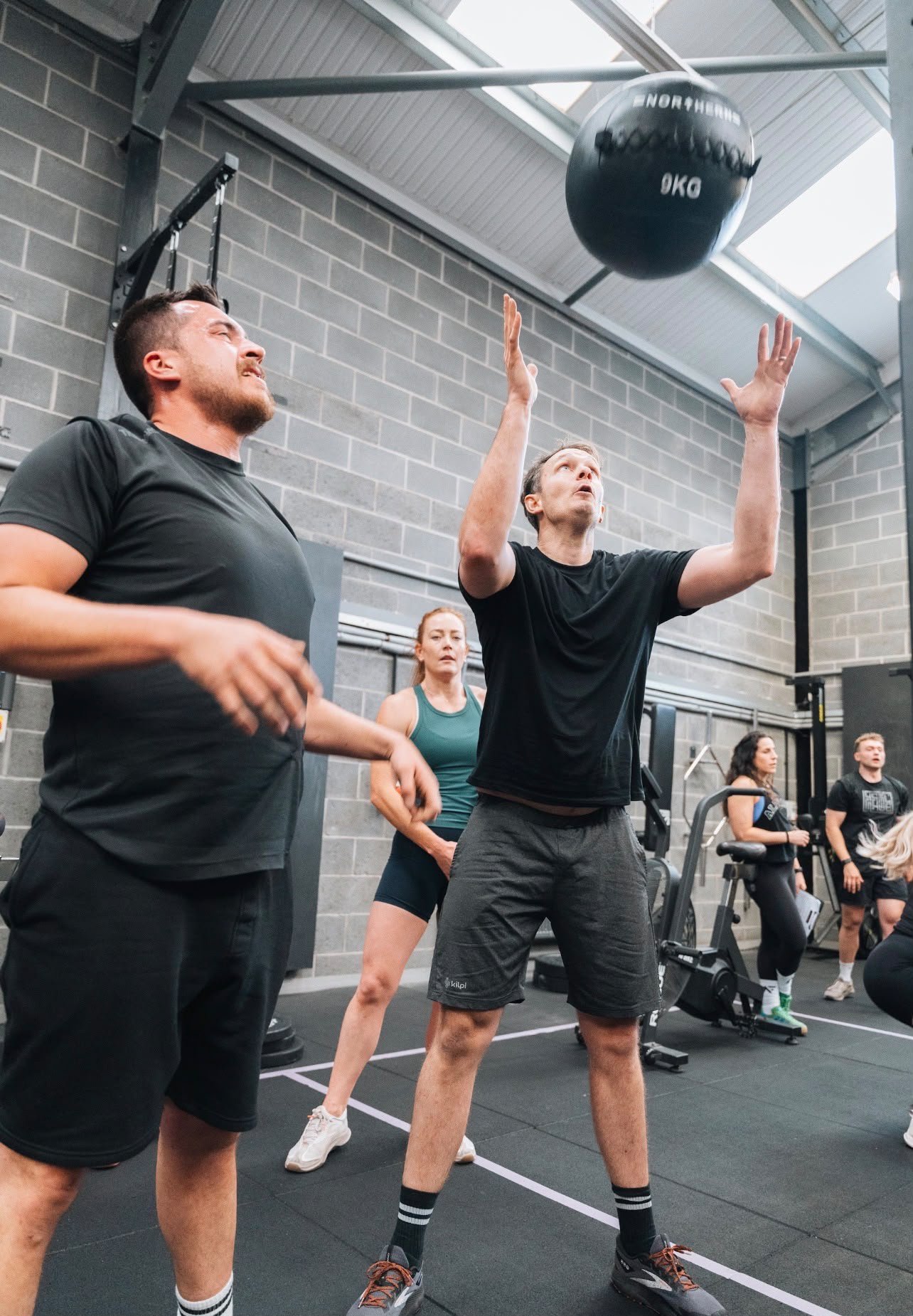 AlphaFit athletes completing wall balls during HYROX training